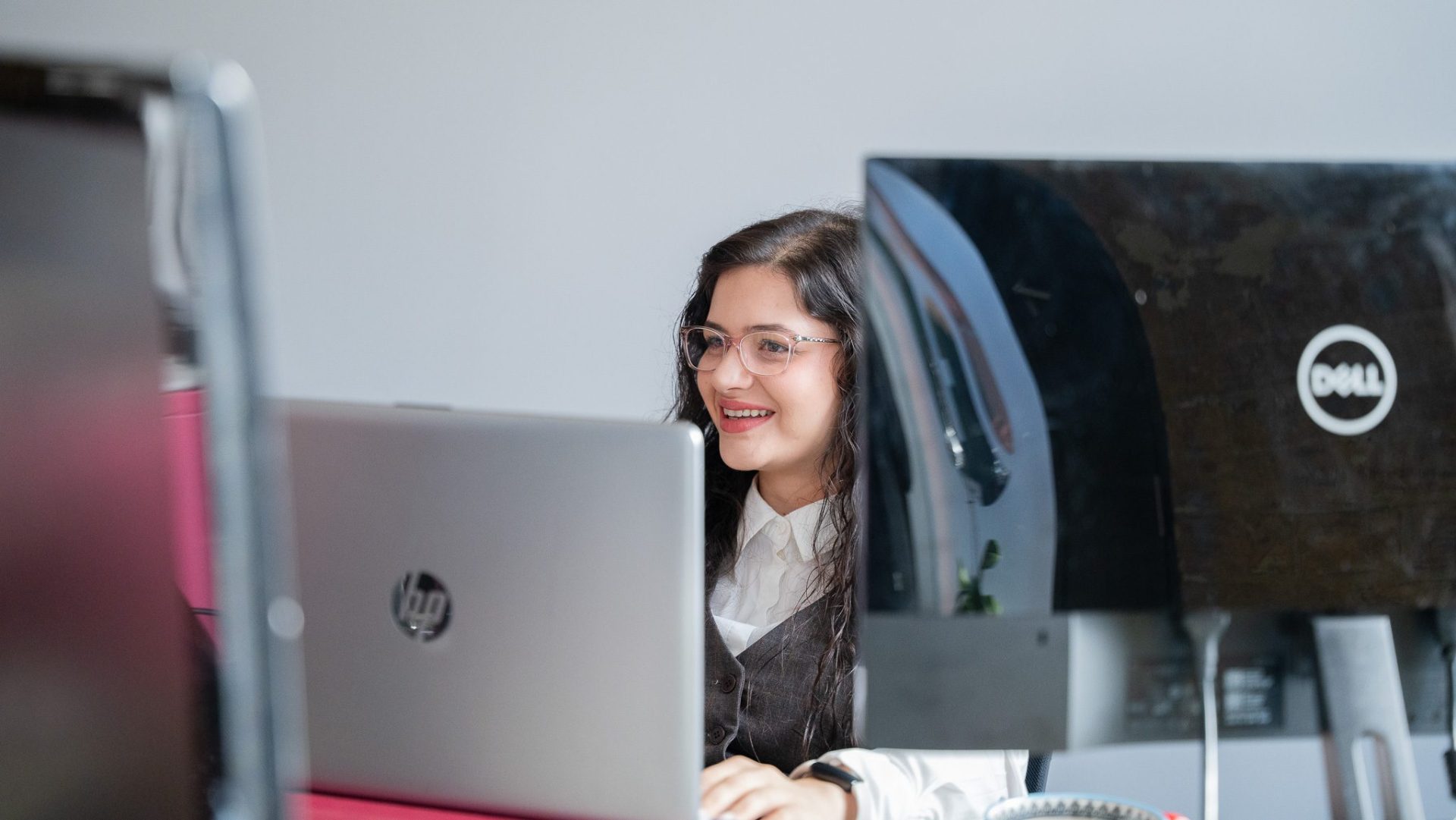 Anca at her desk, smiling. Anca at her desk, smiling.